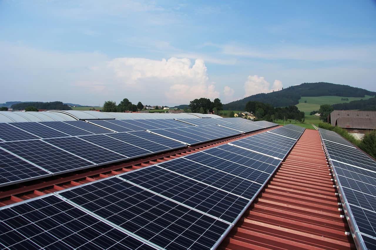 solar panels on commercial building roof sustainability by EcoGreenVision